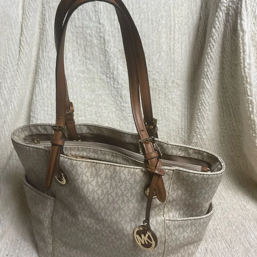 Michael Kors Beige signature Coated Canvas tote , tan leather straps .